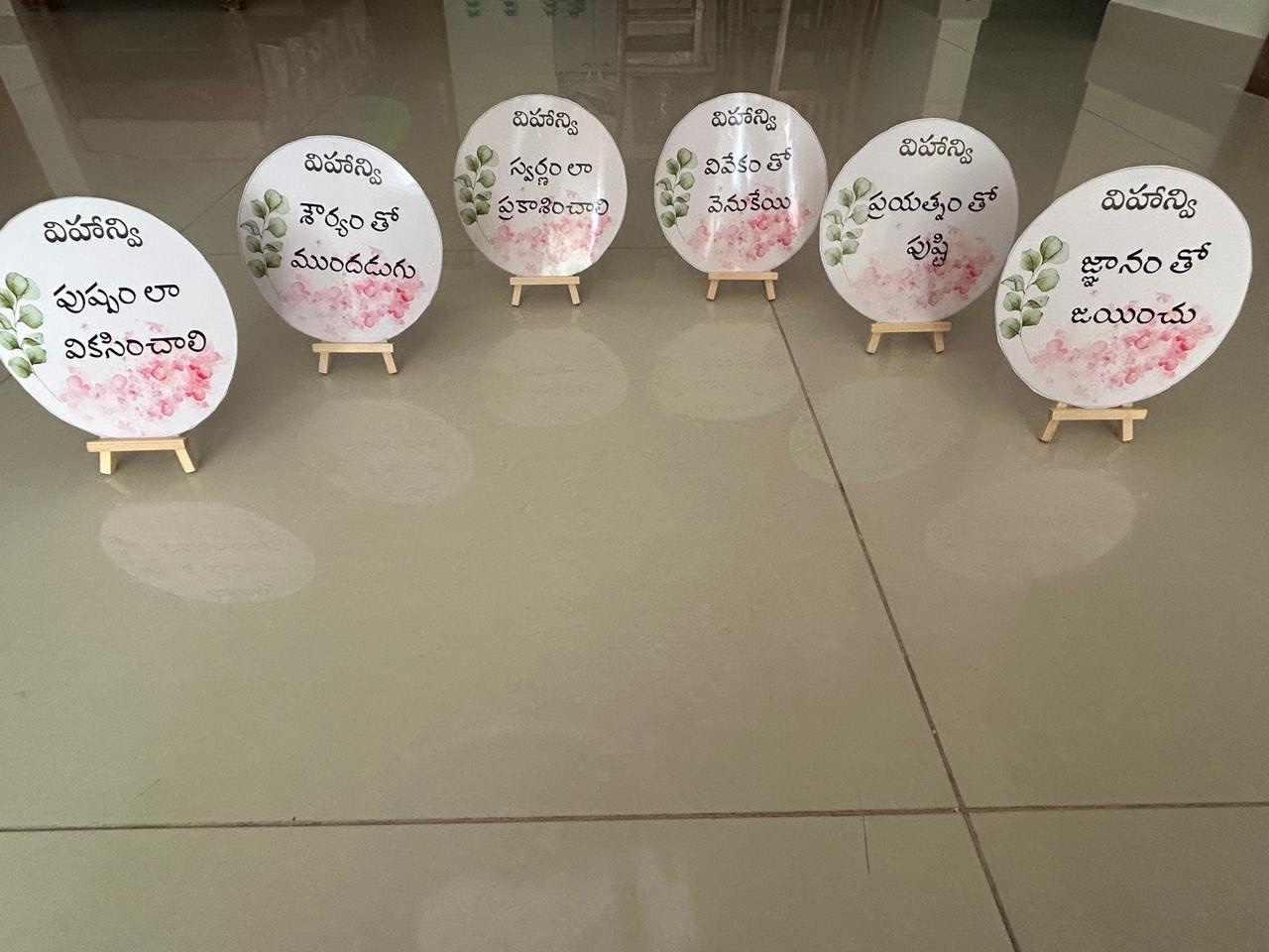 Round Annaprasana blessing cards standing on wooden easels
