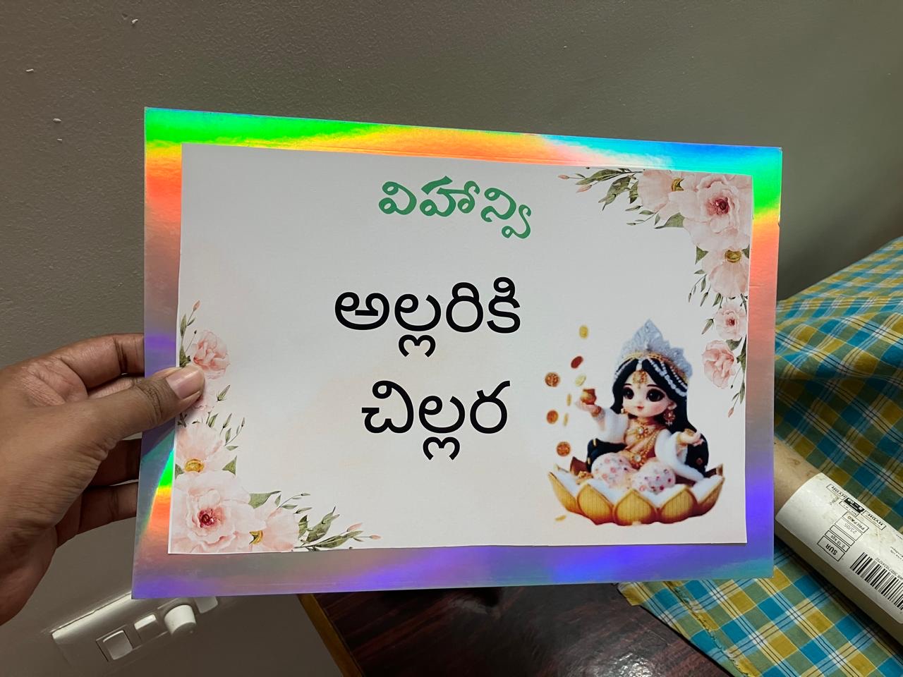 Holographic edged Annaprasana keepsake card held in a hand