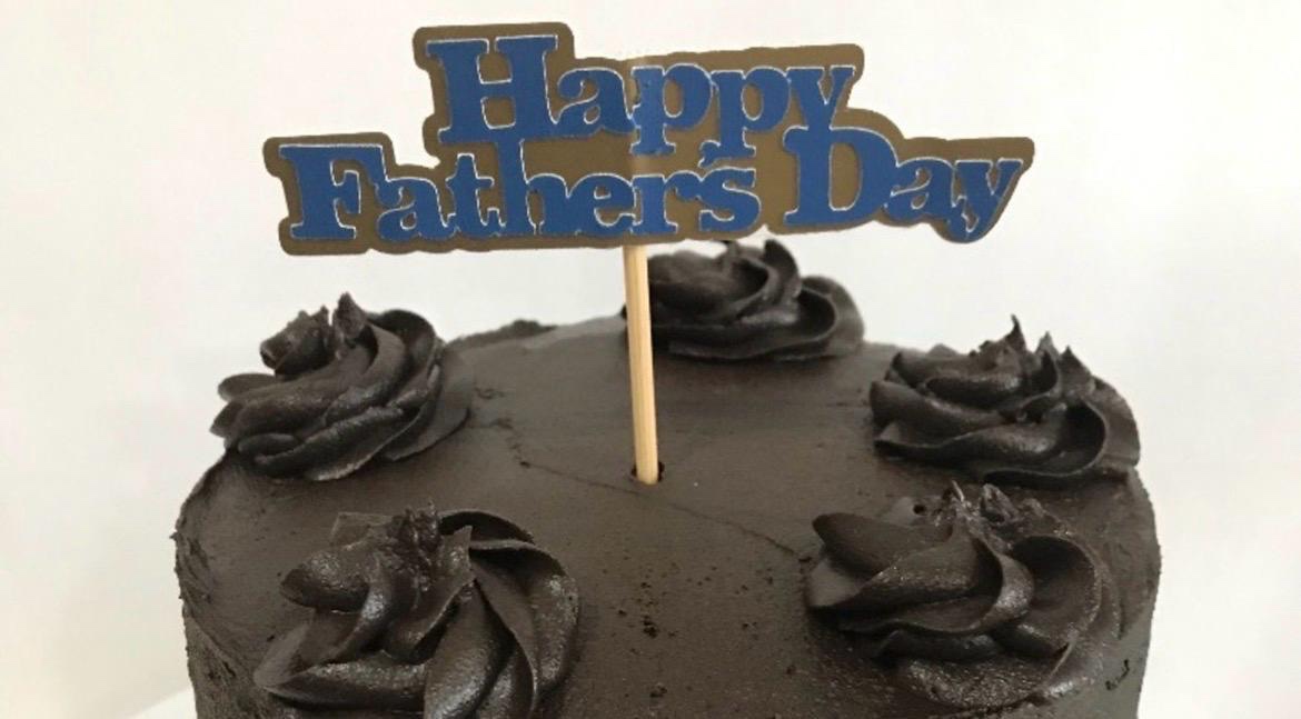 Blue Happy Father's Day topper on a chocolate cake