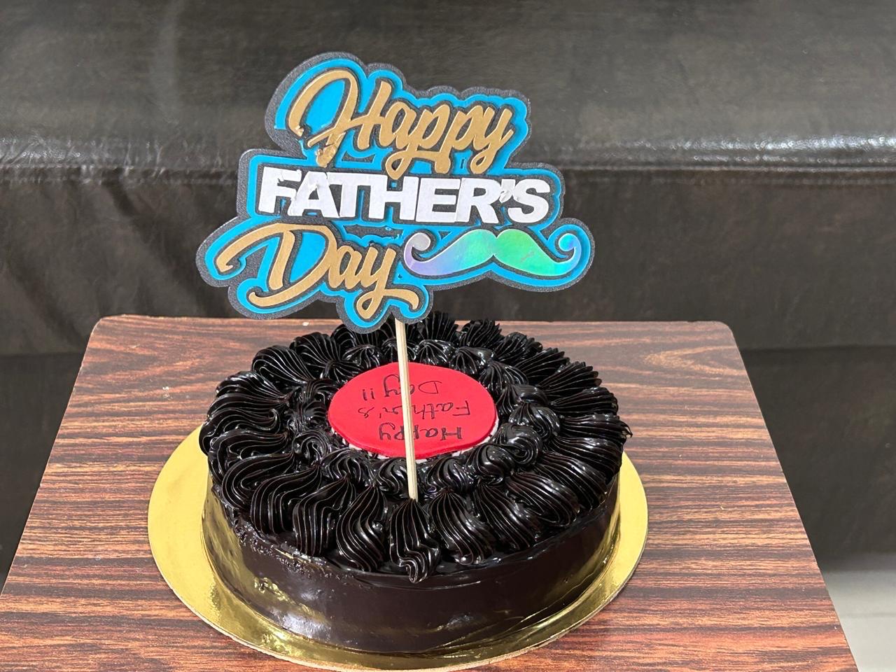 Happy Father's Day topper on a chocolate cake