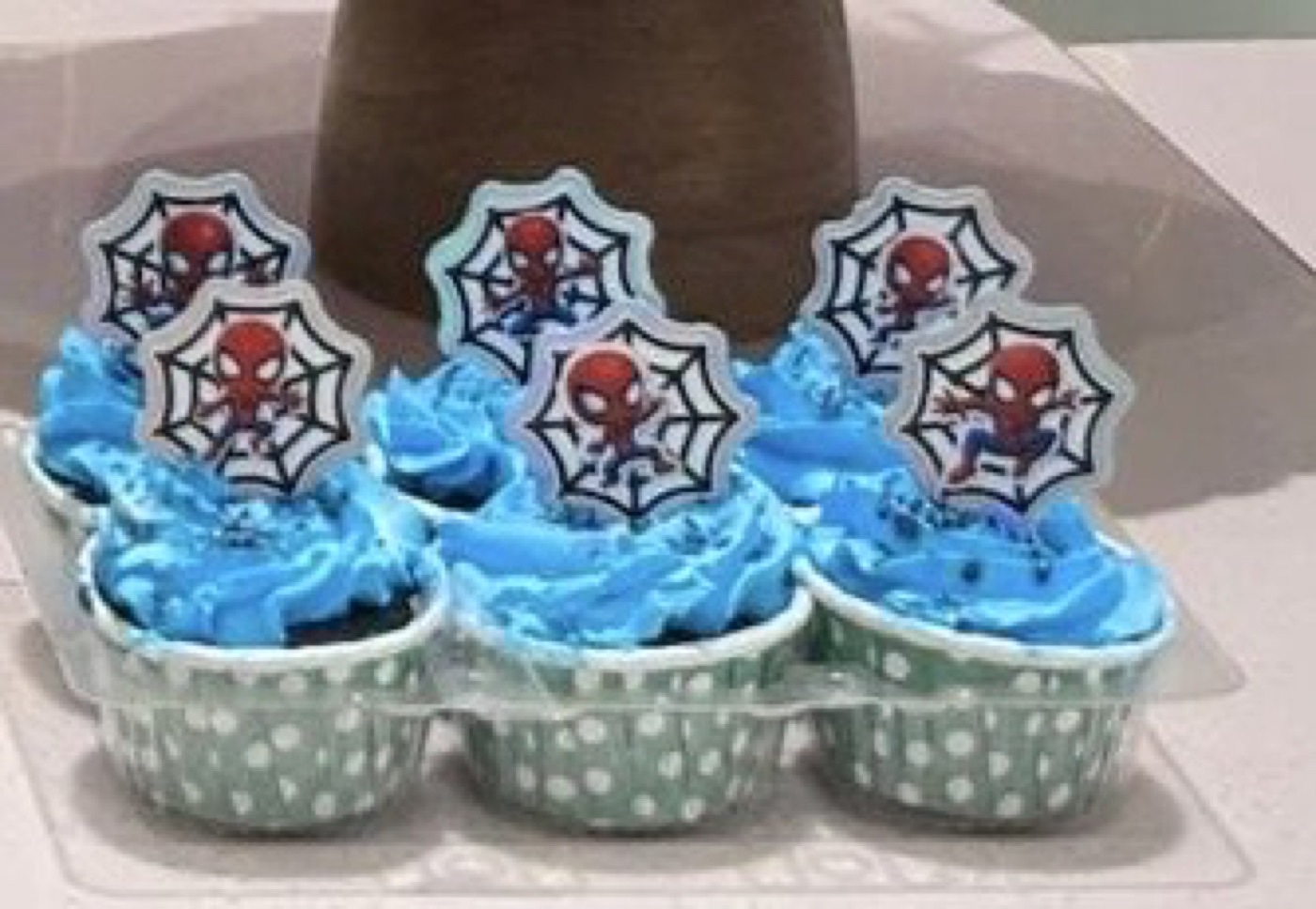 Spider-Man themed party cupcakes with web toppers