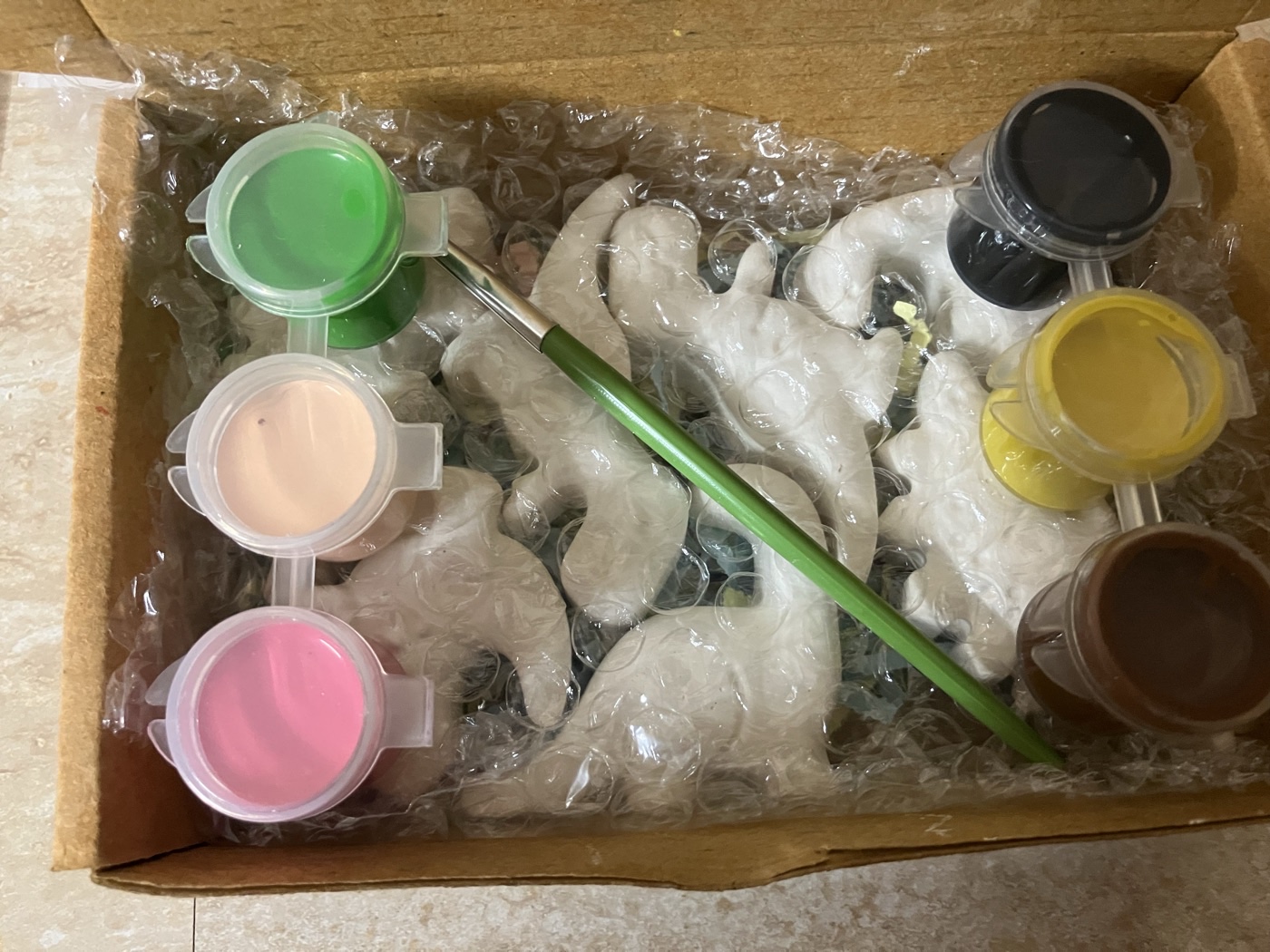 Paints and figures mid-craft on our worktable