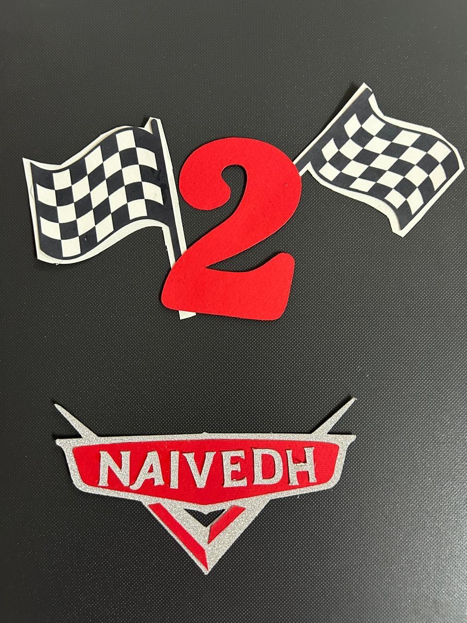 Racing themed number two topper with checkered flags and a name plate