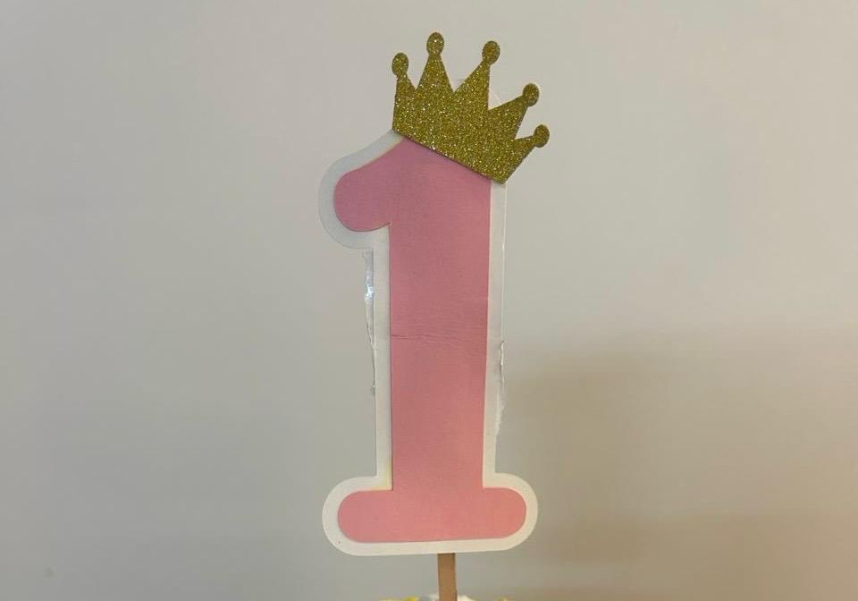Pink number one topper with a gold glitter crown