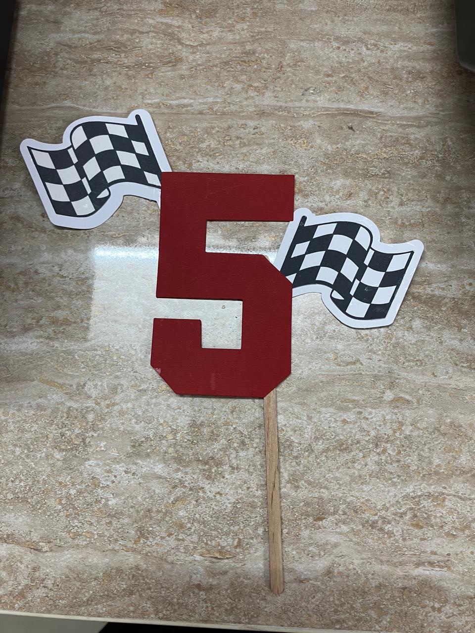 Red number five topper with checkered racing flags